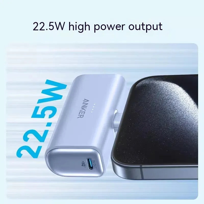 Small capsule-shaped power bank in multiple colours showing built-in foldable USB-C cable and compact size.