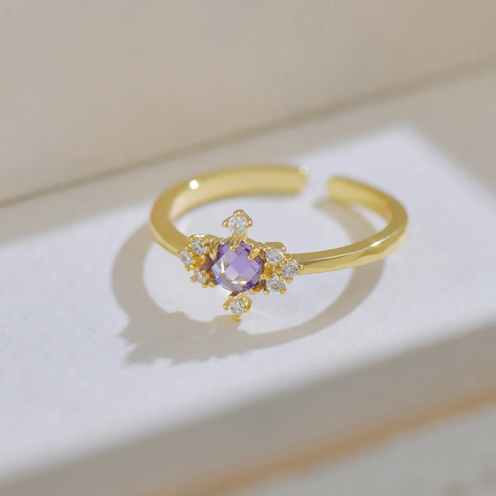 Open mouth geometric ring with round zircon stones on copper band, available in purple or olive green
