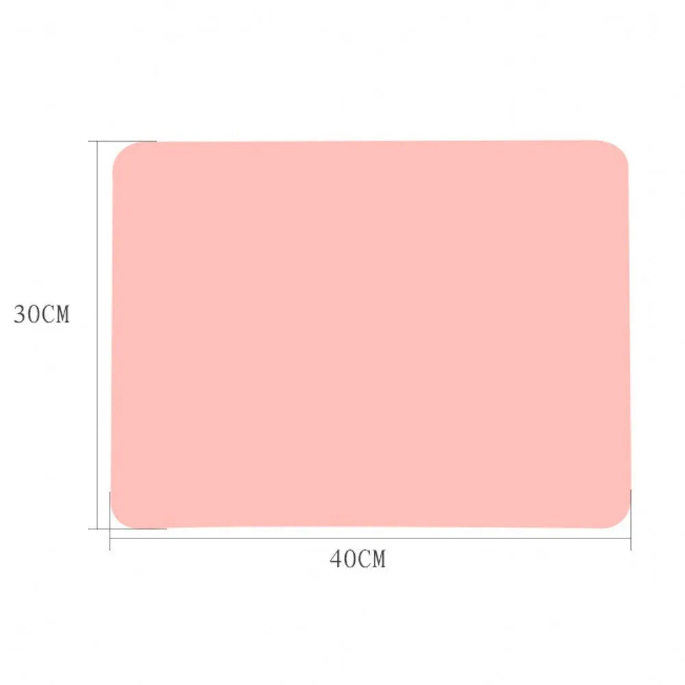 Rectangular silicone pet table mat under a dog bowl, available in multiple colours including black, blue, green, orange, purple, red, white, and yellow