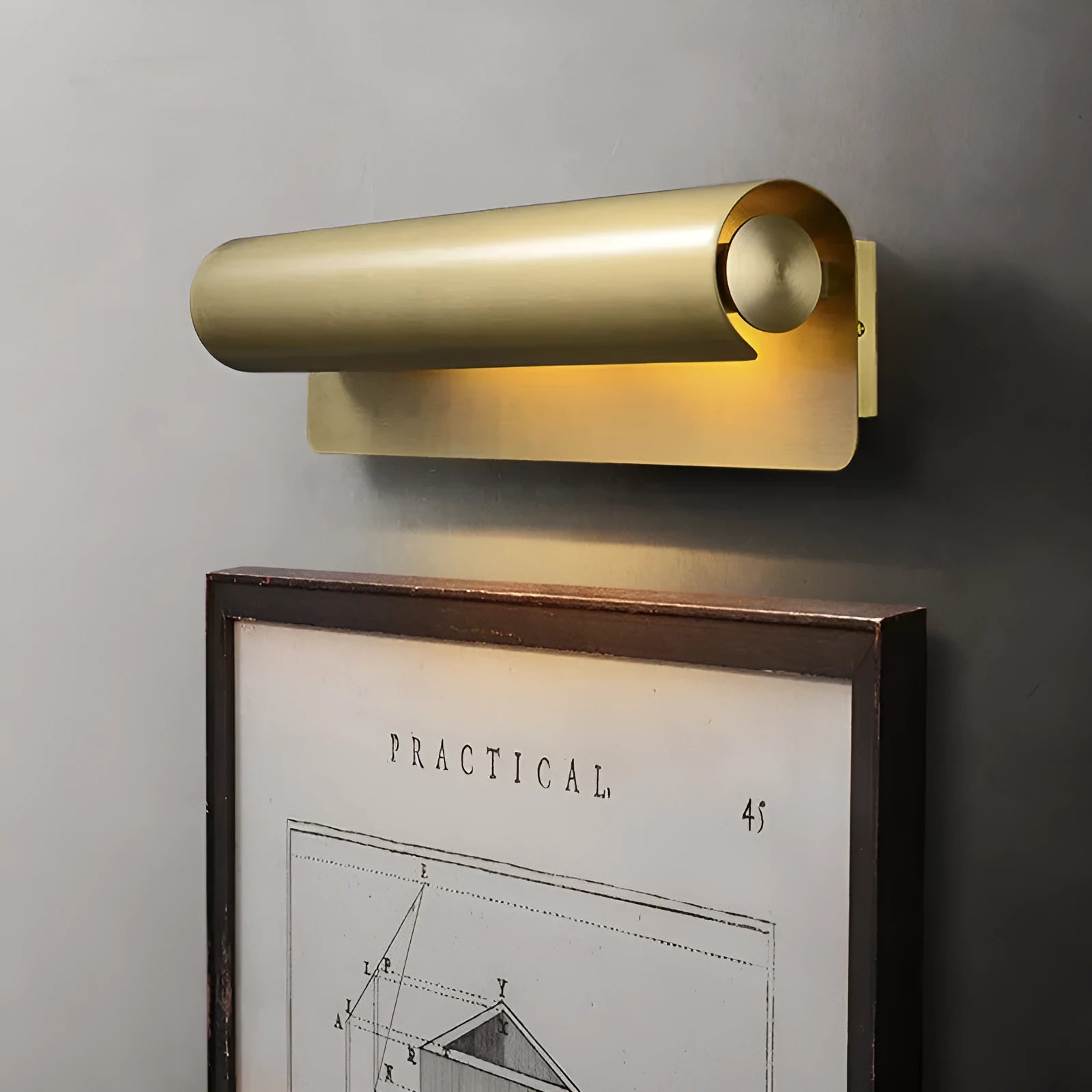 Simple modern copper wall lamp with warm light, 26cm long, on a living room wall