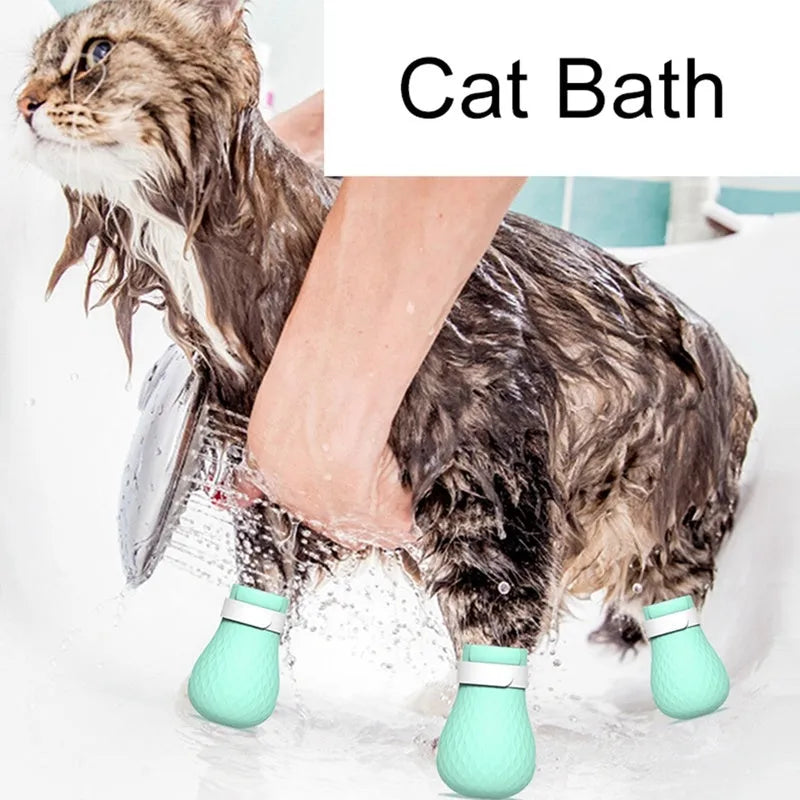 Green silicone cat foot covers with nylon buckle strap and leak hole design, set of 4 pieces on a white background