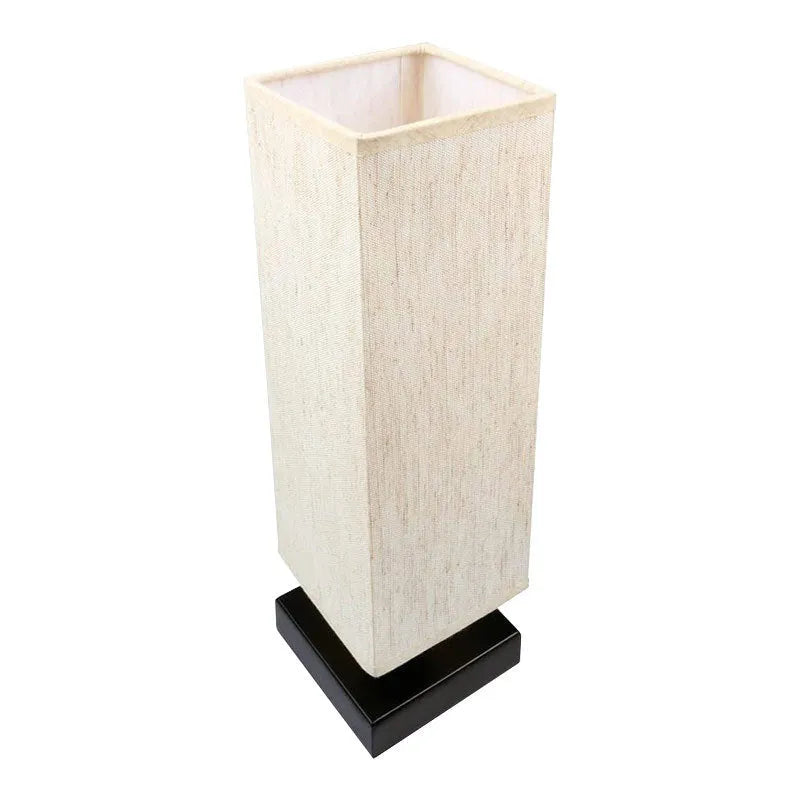 Modern square cloth covered table lamp with E26 socket on a wooden desk