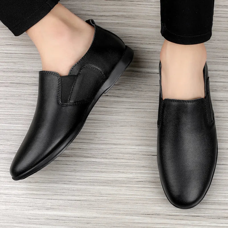 Men's black and brown cowhide leather shoes with round toes on a white background.
