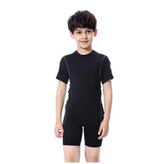 Children's black and green sportswear set showing T-shirt, trousers, and shorts on a size chart.