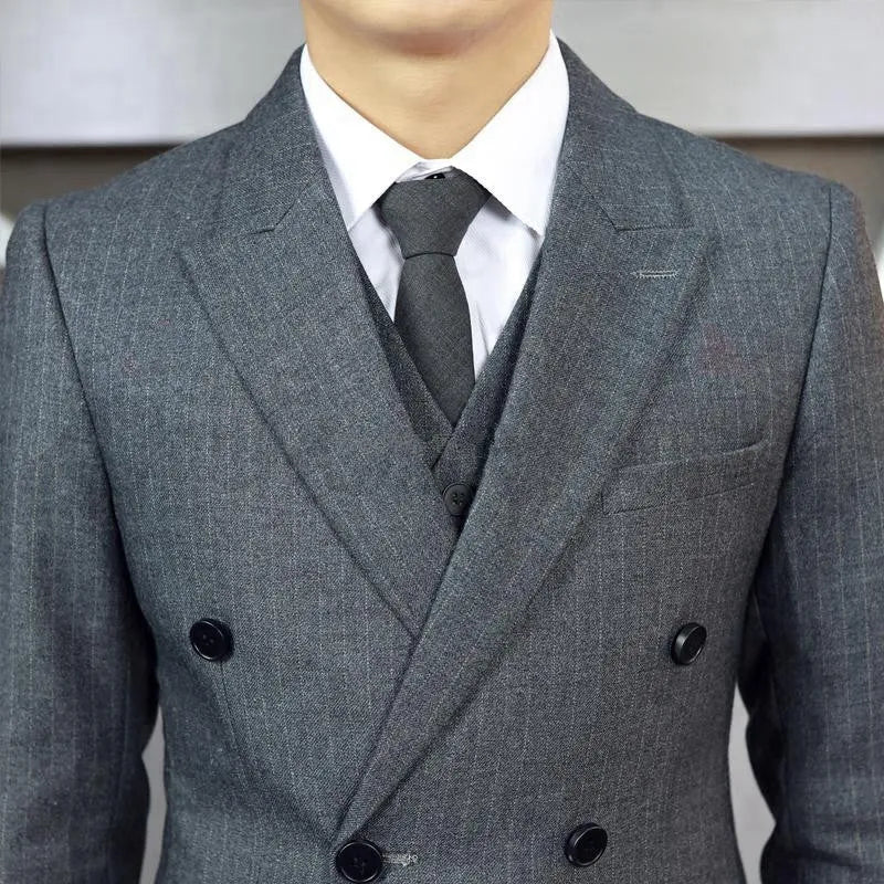 Men's black three-piece suit set with jacket, vest, and trousers, slim fit, anti-wrinkle fabric, on a mannequin.