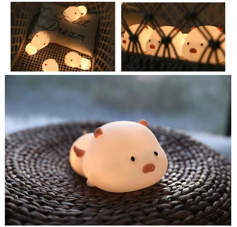 Blue rechargeable silicone night light shaped like a sleeping pig with soft LED glow.