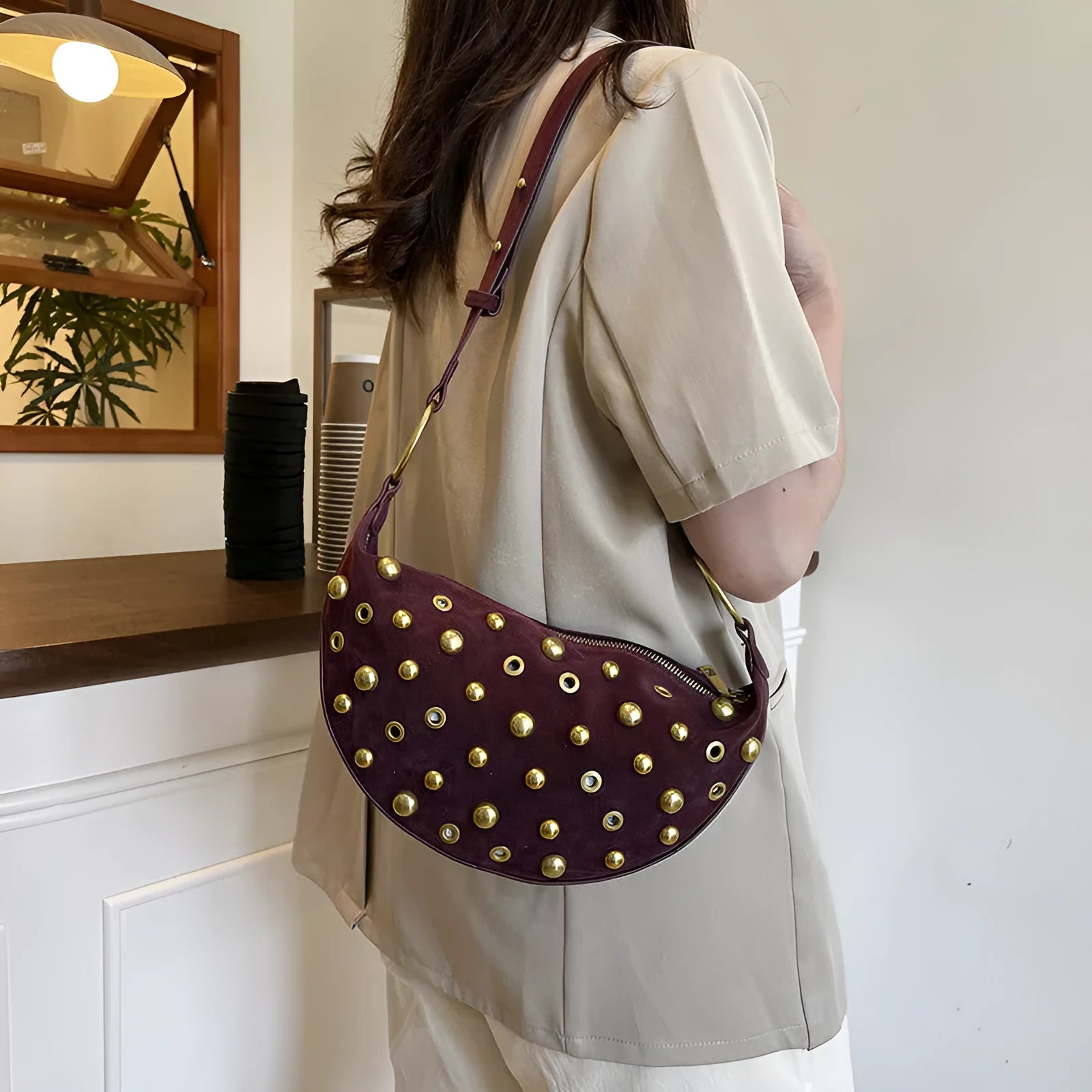 Retro rivet shoulder bag in frosted imitation buckskin with single strap and sewing line detail on a white background