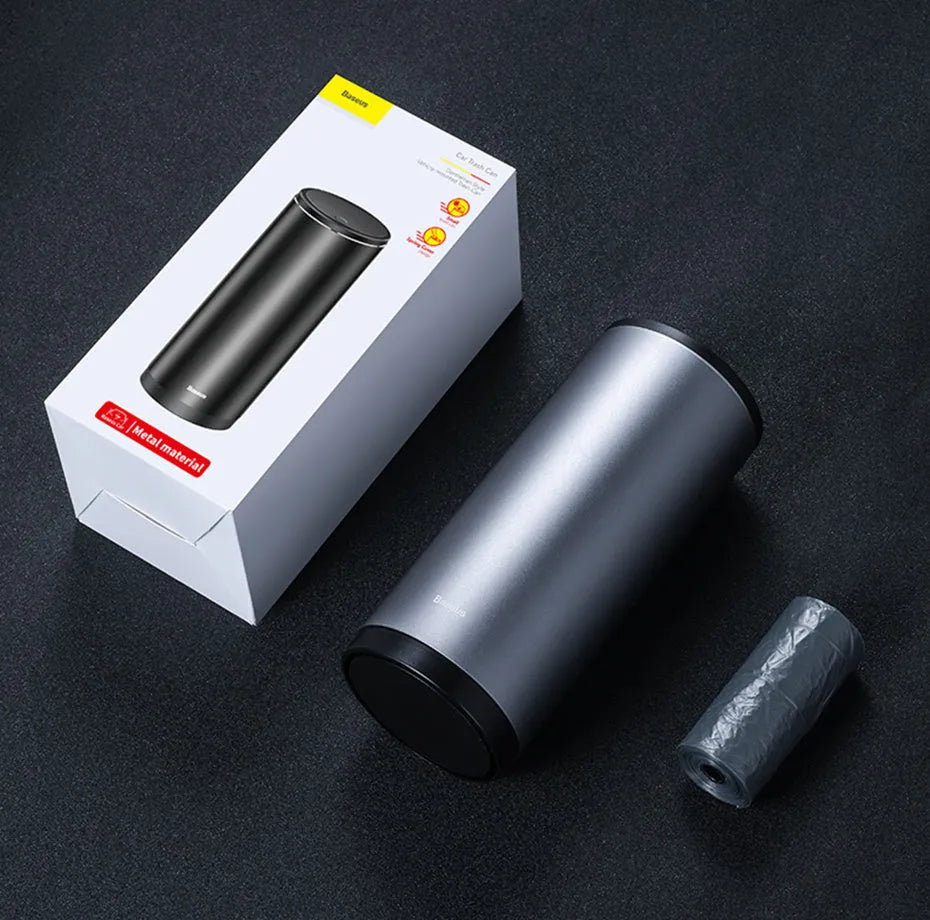 Compact aluminium alloy car trash bin with black finish, 500mL capacity, and click-open lid, placed in a vehicle cup holder