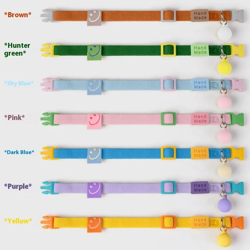 Small elastic dog collar in dark blue, stretched to show flexibility on a measuring tape from 22 to 32 cm.