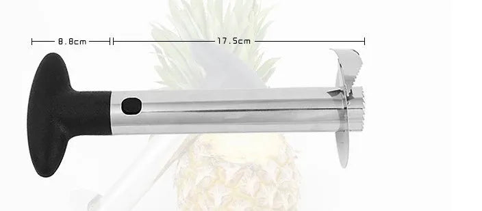 Stainless steel pineapple corer slicer with black plastic handle on a kitchen worktop.