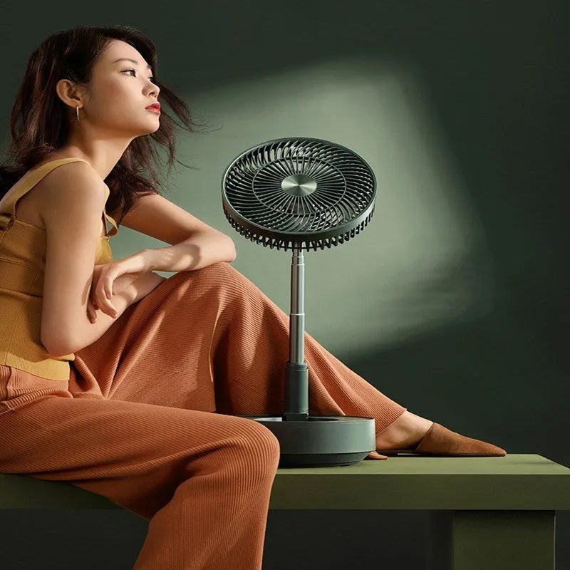 Green telescopic storage floor electric fan shown in both desktop and extended vertical configurations with remote control