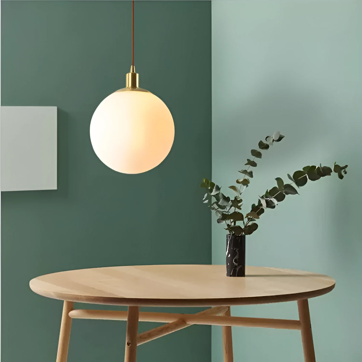 Nordic glass round spherical chandelier in milk white with copper fittings on a light background