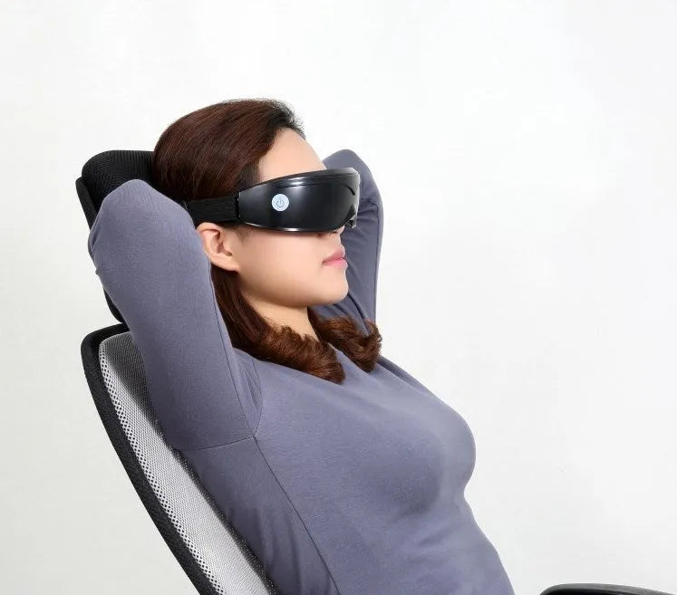 Eye massager with adjustable headband, silicone contacts, and 9 vibration modes in black and white colour