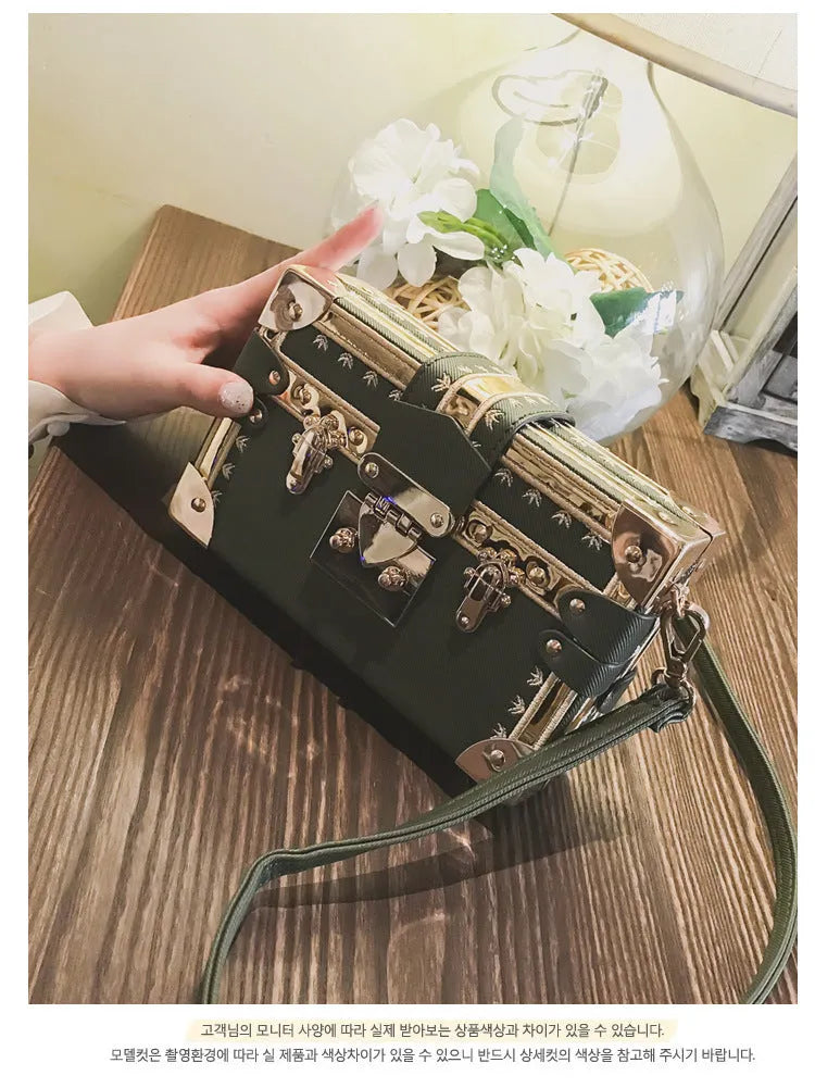 Structured hard PU women's shoulder bag with a flap, hasp closure, and adjustable strap.