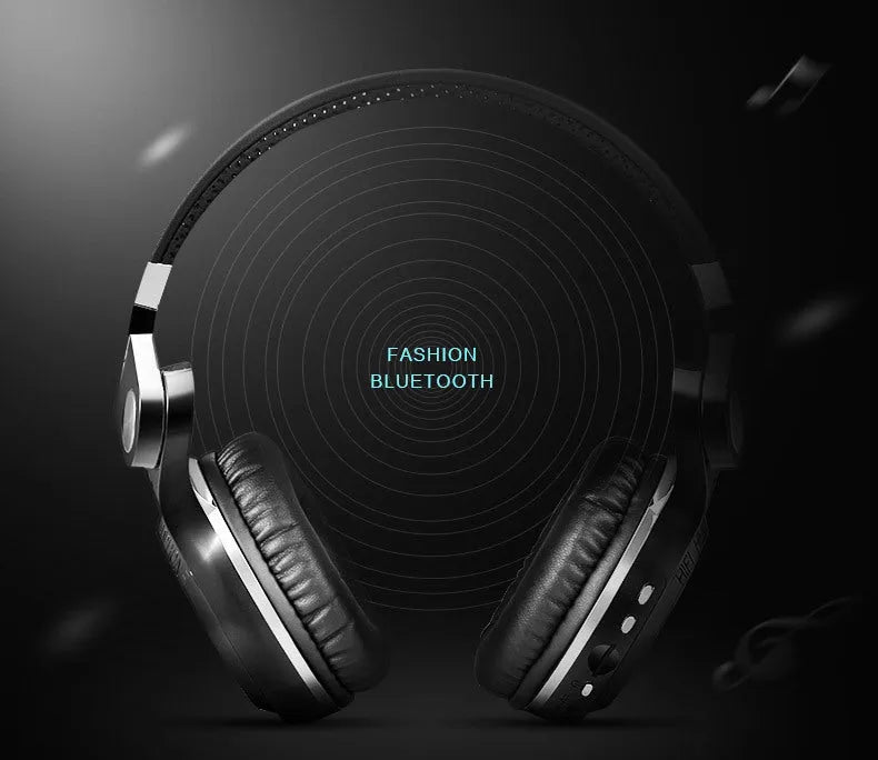 Black Bluetooth headset with head-mounted design and over-ear cushions on a table.