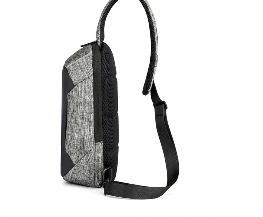 Dark blue Oxford cloth chest bag with a zip and adjustable strap, shown with a phone in its dedicated internal pocket.