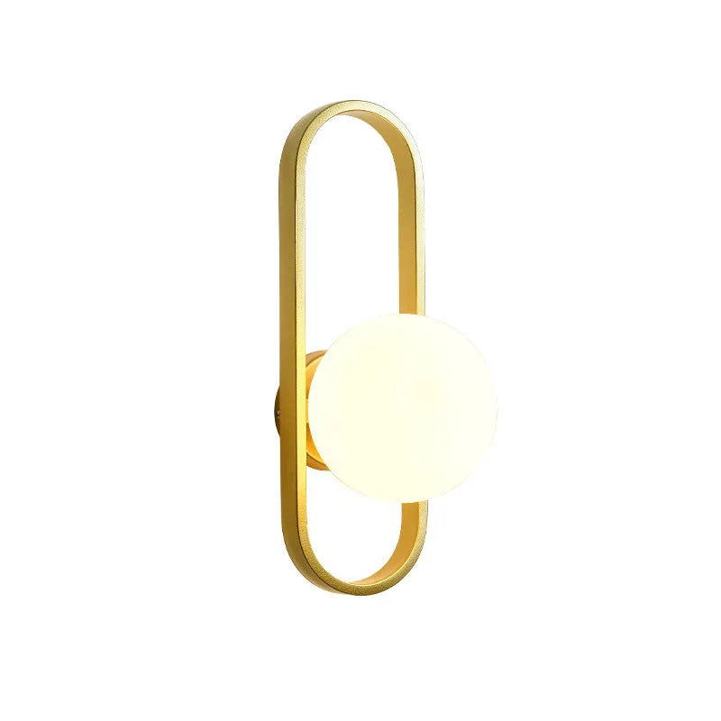 Minimalist wall-mounted lamp with clear glass bulb shade on a black iron sconce arm and backplate.