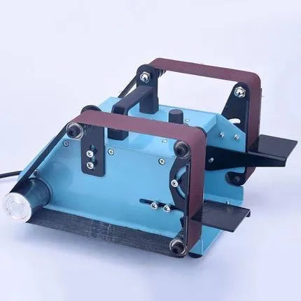 Blue desktop dual-axis belt sander with variable speed switch, shown with a 40mm abrasive belt fitted.