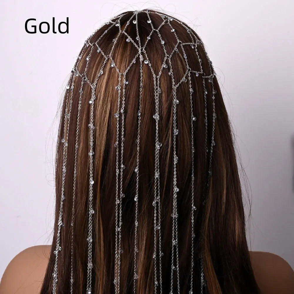 Close-up of a gold rhinestone mesh headband for women with a dangling tassel decoration.
