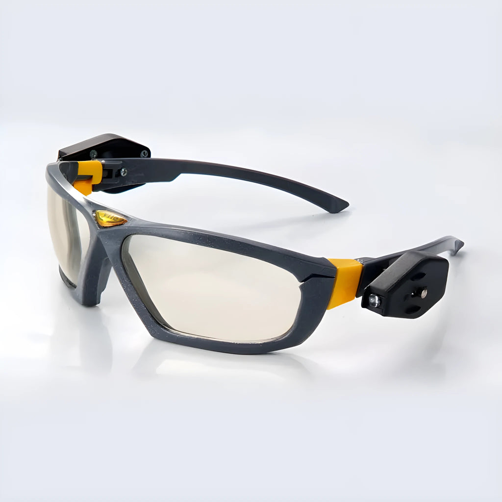 Yile anti impact goggles with LED lamp on a workbench showing protective eyewear and integrated light