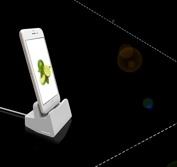 White plastic headphone charging base for wireless earbuds on desk