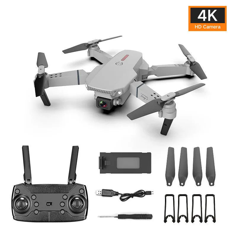 Grey foldable 4K dual camera drone with remote controller and carry bag, shown with propeller blades extended.