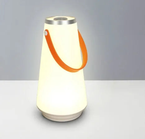 White rechargeable LED bedside lamp with adjustable brightness on wooden table