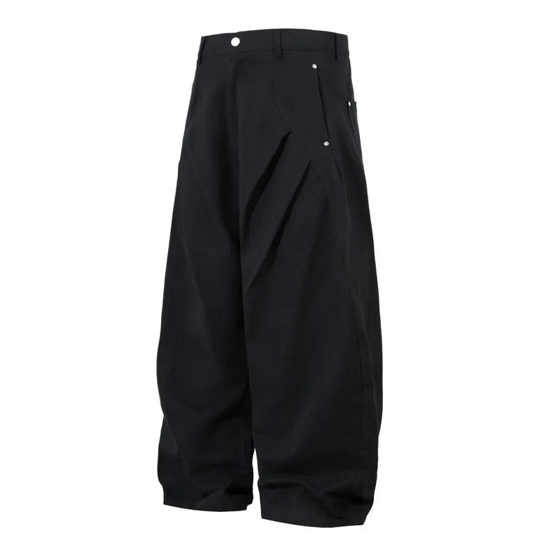 Men's black pleated wide-leg cotton trousers showing loose-fitting casual design