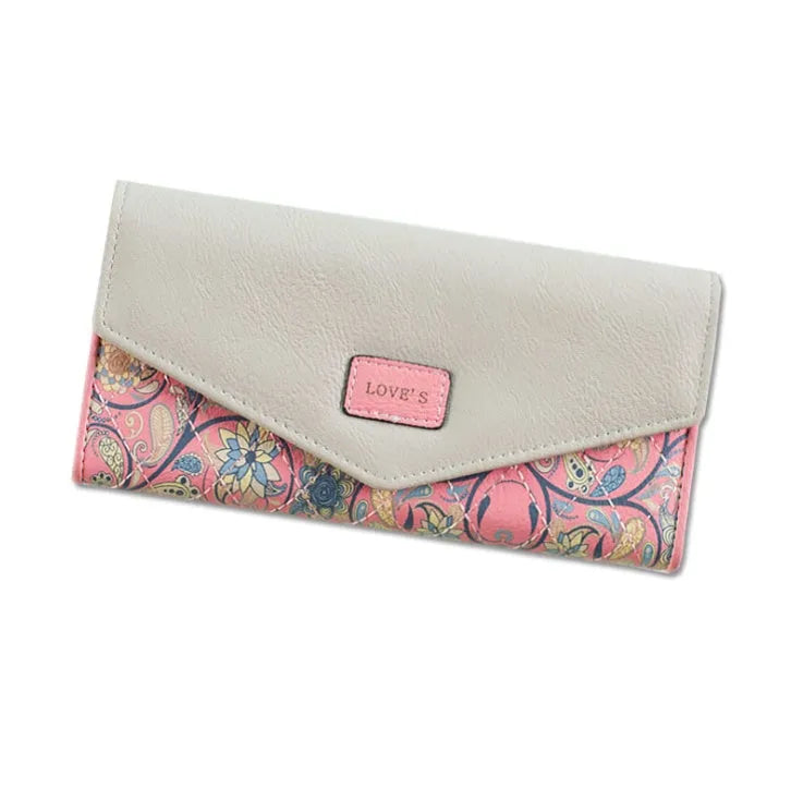 Women's three-fold leather wallet with buckle closure showing melon red colour option