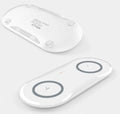Black and white dual wireless charging pad charging two smartphones simultaneously