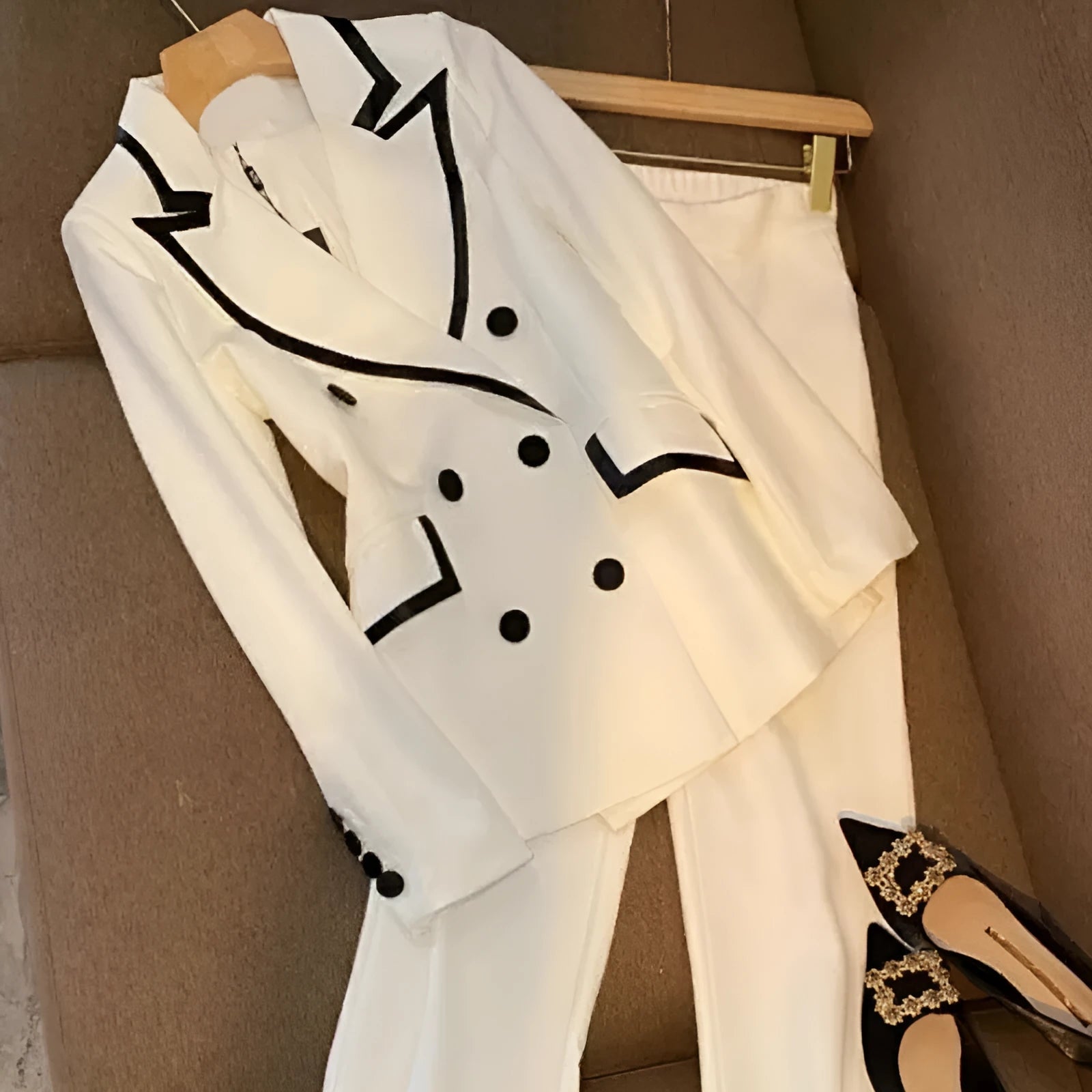 White polyester women's formal suit set with blazer top and matching trousers