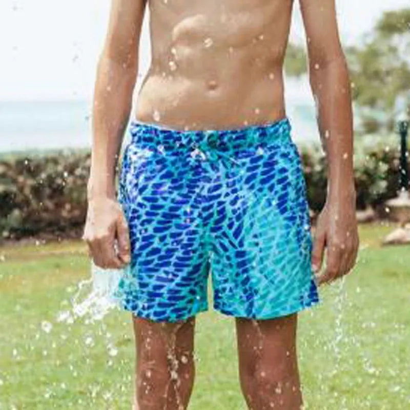 Thermochromic children's polyester shorts in solid blue colour changing to green when warm