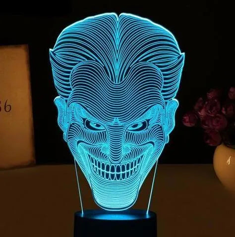 USB-powered 3D LED desk lamp showing multiple colour modes on an acrylic panel with a remote control.