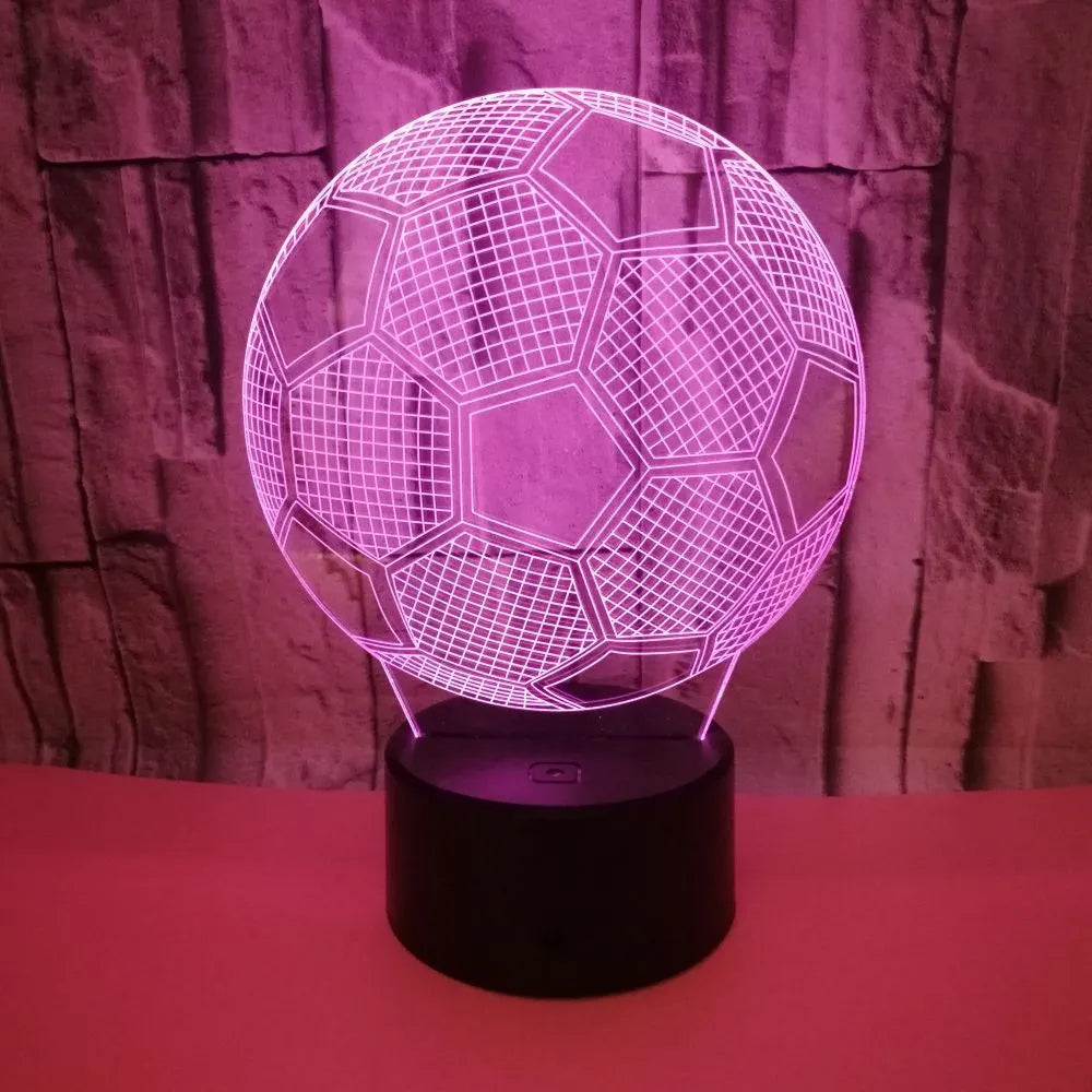 3D football-shaped LED night light on a black base showing multi-colour gradient illumination.