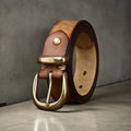 Men's black genuine leather casual belt with a copper pin buckle, showing length adjustment holes.