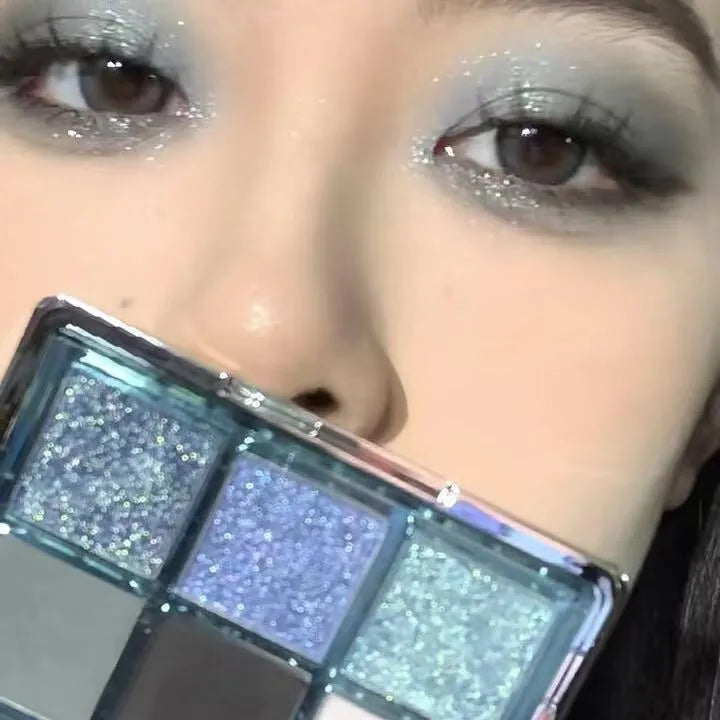 MUGELEEN nine-colour eyeshadow palette showing low saturation blue and earth tones with diamond debris effect