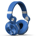 Black Bluetooth headset with head-mounted design and over-ear cushions on a table.