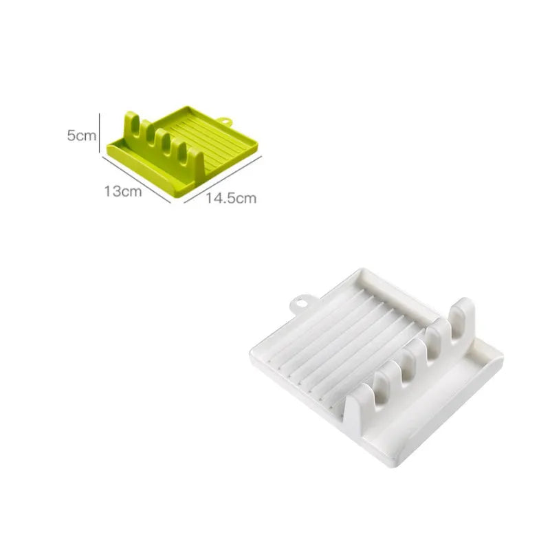 Green silicone 4-hole kitchen spatula holder with chopsticks and spoon on clean countertop