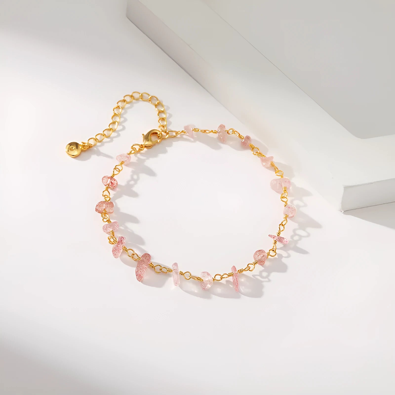 Geometric women's copper bracelet with irregular turquoise gravel stones and crystal accents on a white background.
