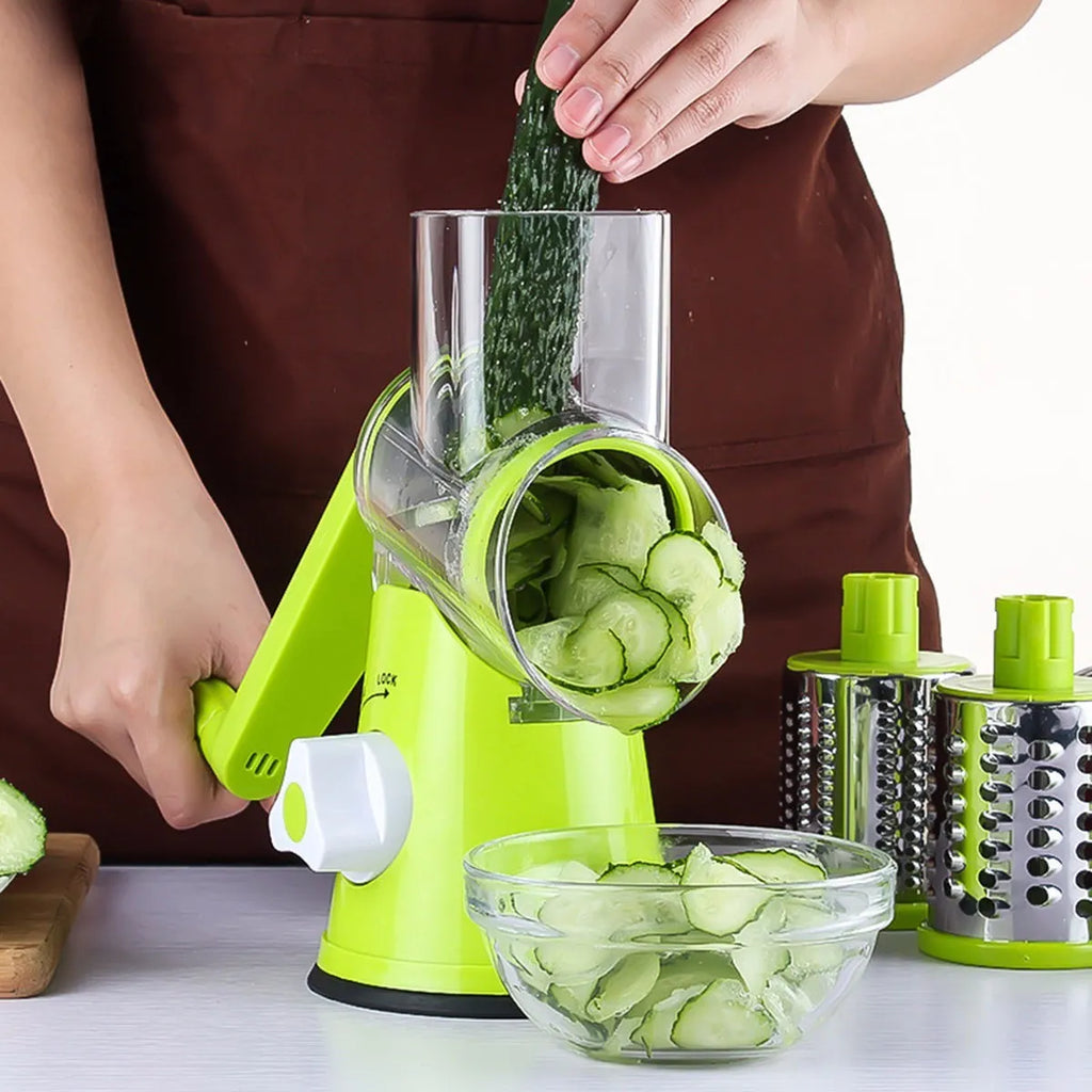 Round mandoline vegetable cutter with three stainless steel drum blades and sucker base on a worktop