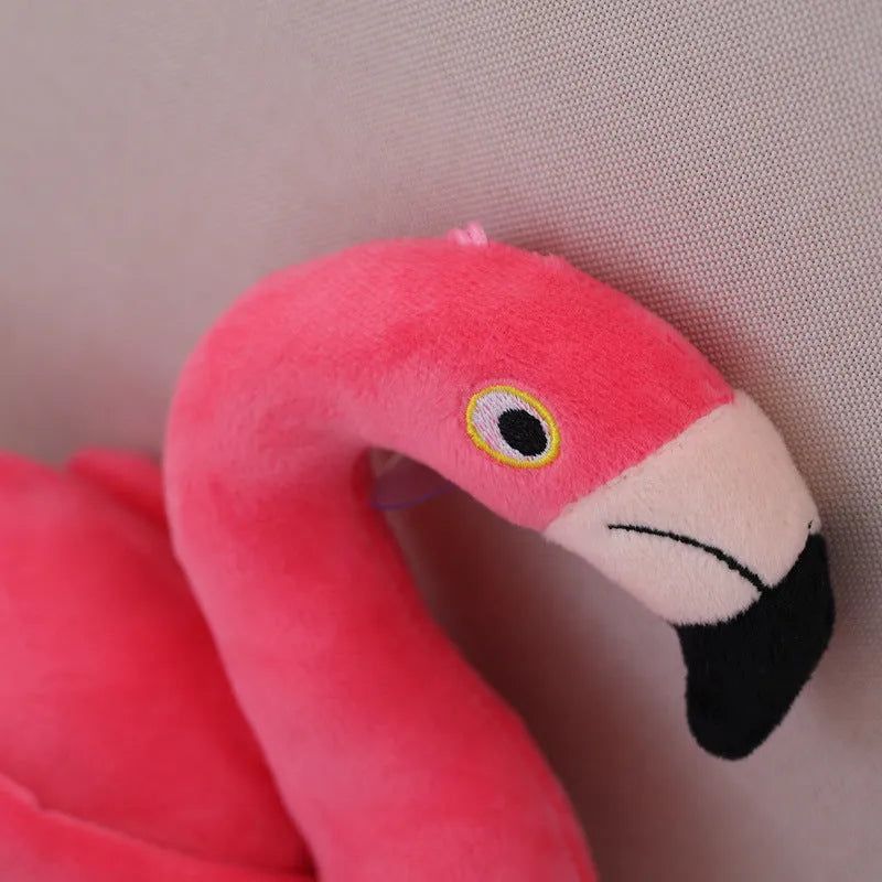 Pink flamingo plush toy with short plush fabric, filled with PP cotton, sitting on a surface