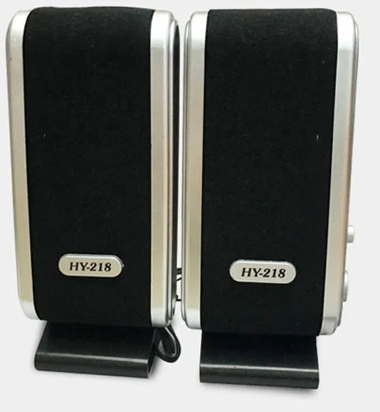 A black notebook mini speaker with a USB cable for computer audio.