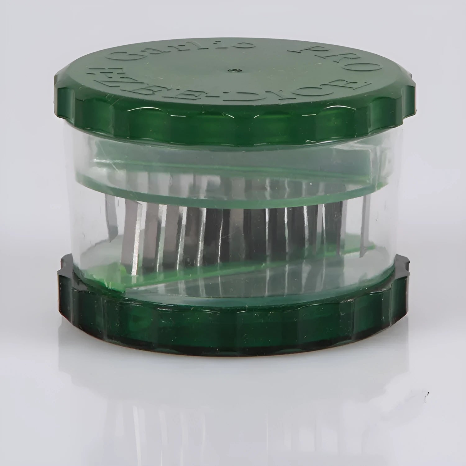 Green transparent PP plastic garlic peeler, 8.5 x 8.5 x 6 cm, on kitchen surface