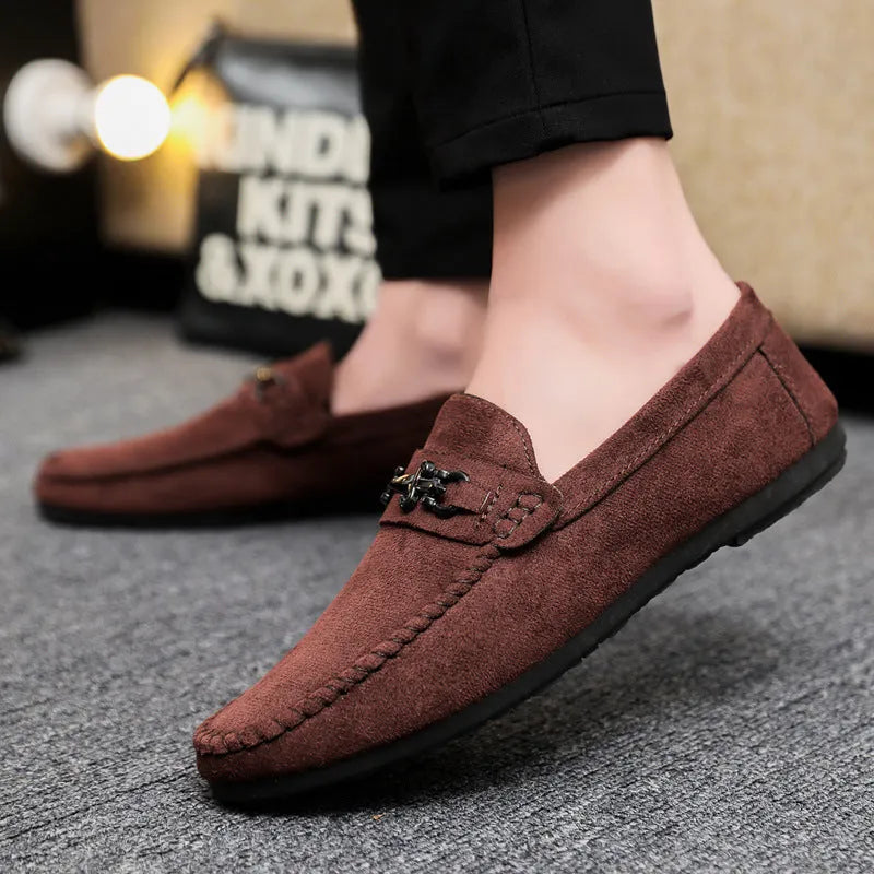 Men's black slip-on loafers with round toe and low stiletto heel, showing sewing thread detailing on artificial PU leather upper
