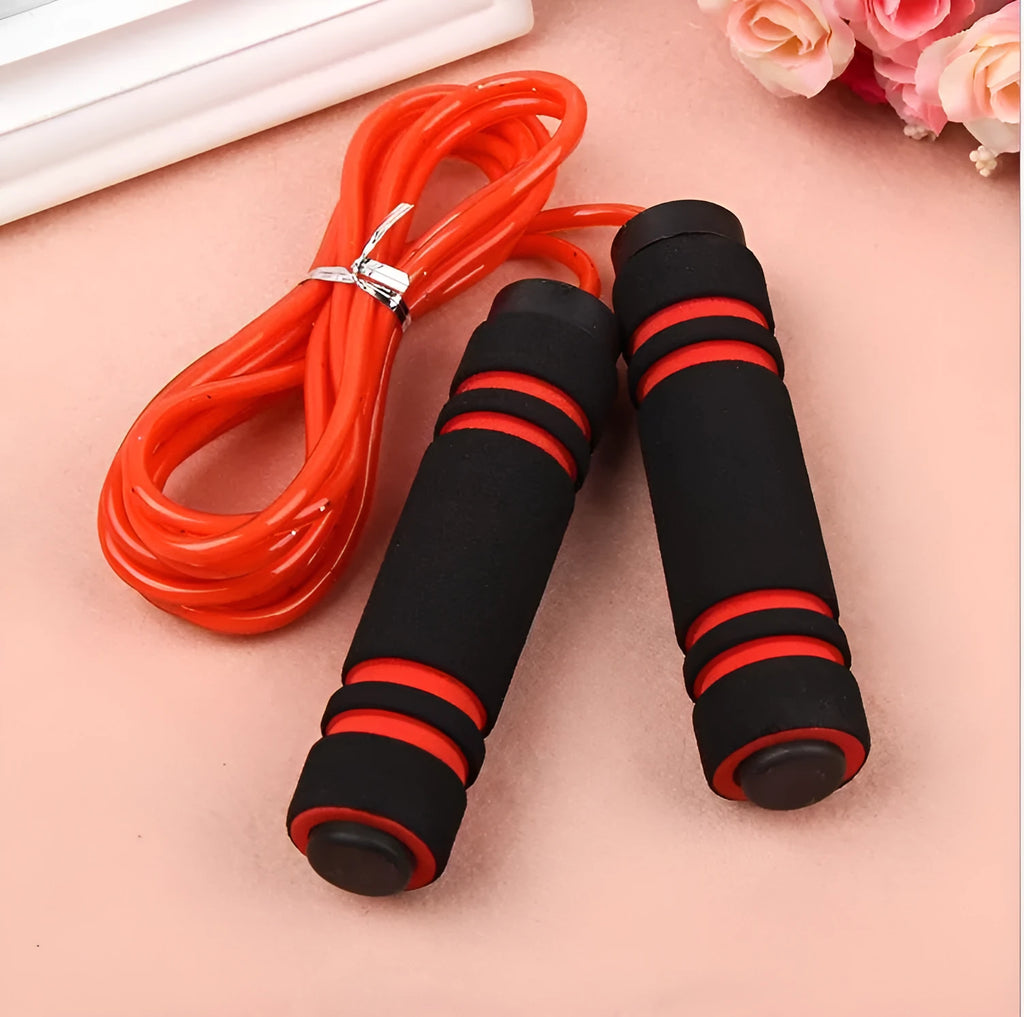 Adjustable Jump Fit Rope with black weighted handles and red speed rope on a dark workout mat