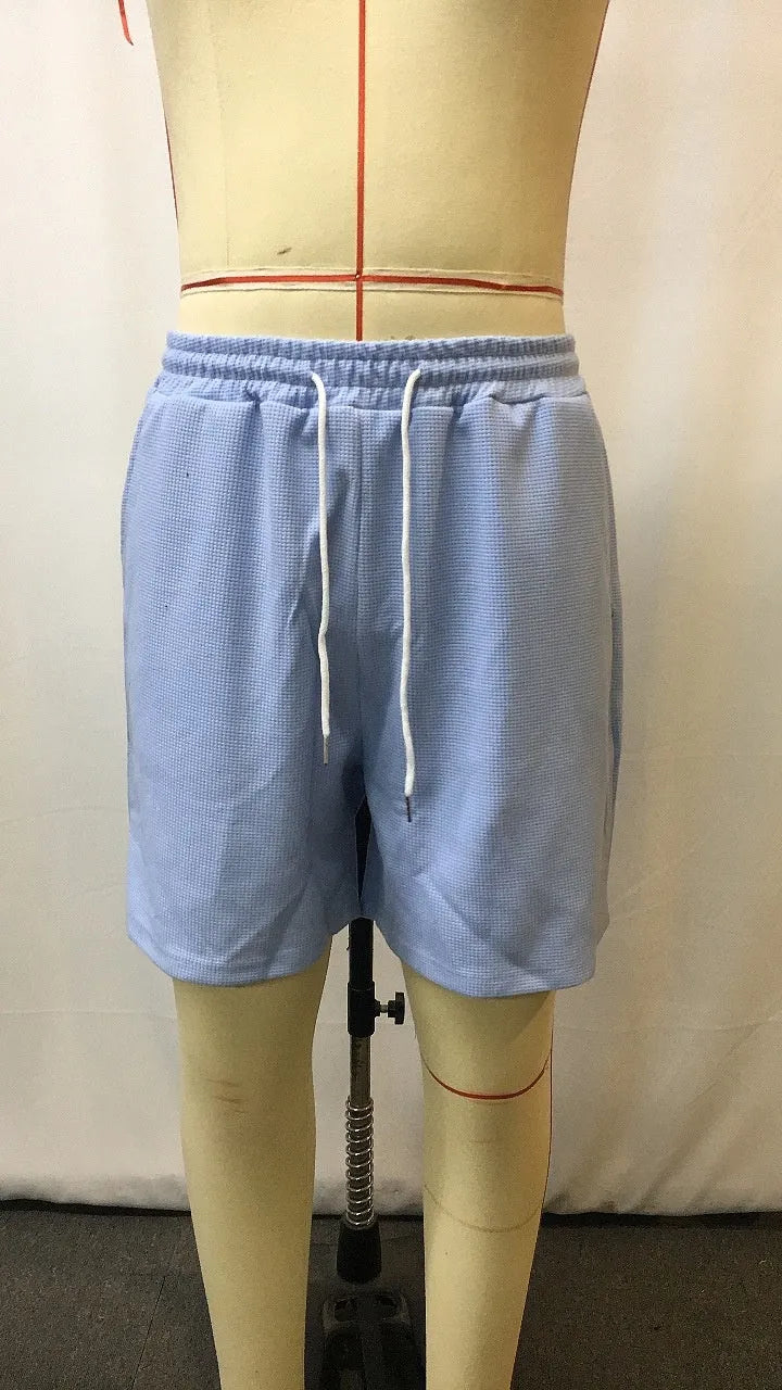 Men's light blue retro waffle knitted stretch surfing shorts with wide leg, front view