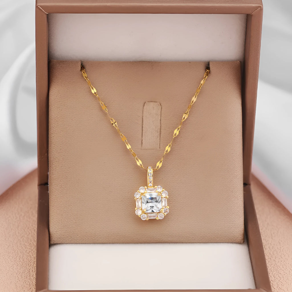 Gold geometric quadrilateral pendant necklace with gem inlay on a water wave chain.