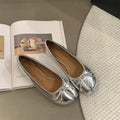 Women's flat split-toe pumps in beige with round toe and rubber sole.