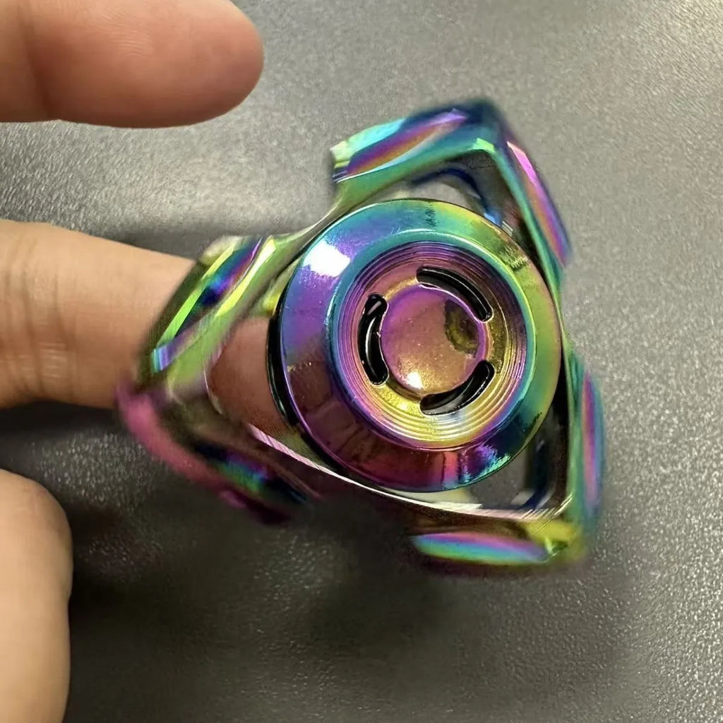 Close-up of a silver and colourful alloy metal fingertip gyro decompression spinner toy.
