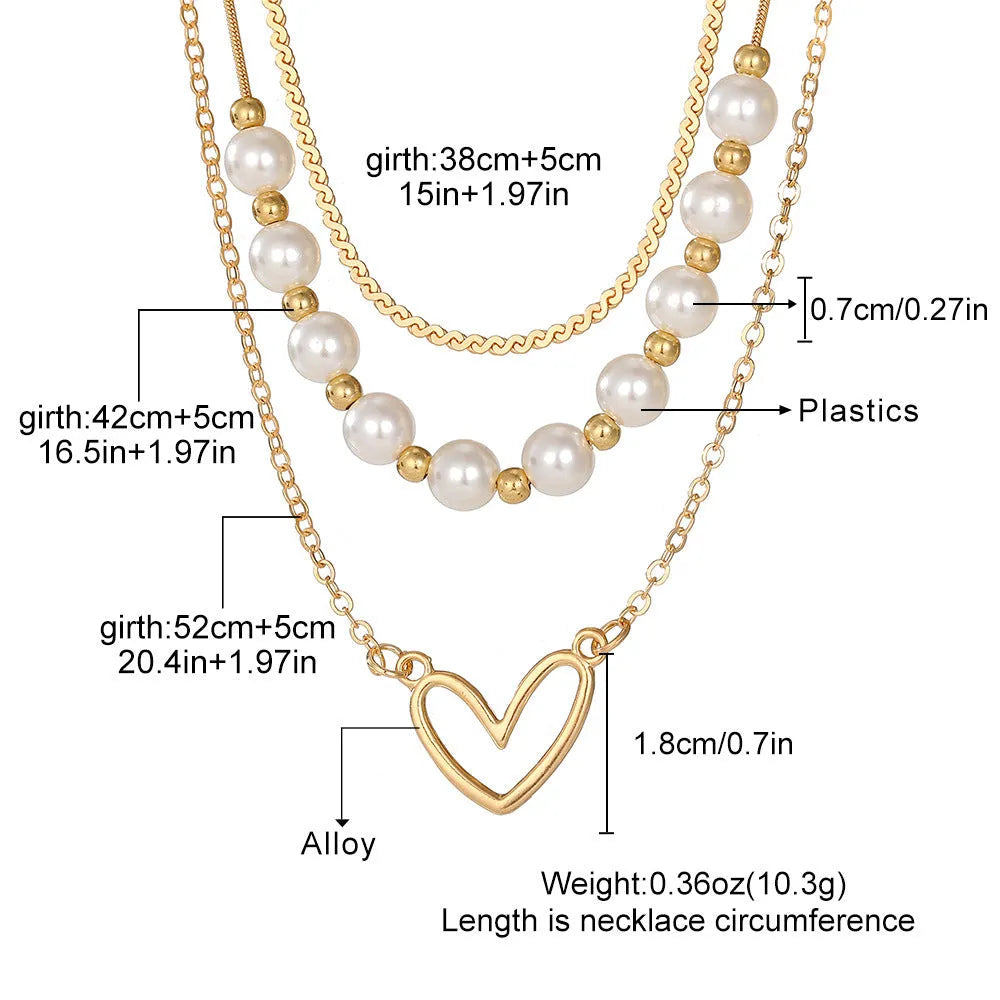 Gold tone heart-shaped pendant necklace with pearl chain, vintage love symbol jewellery